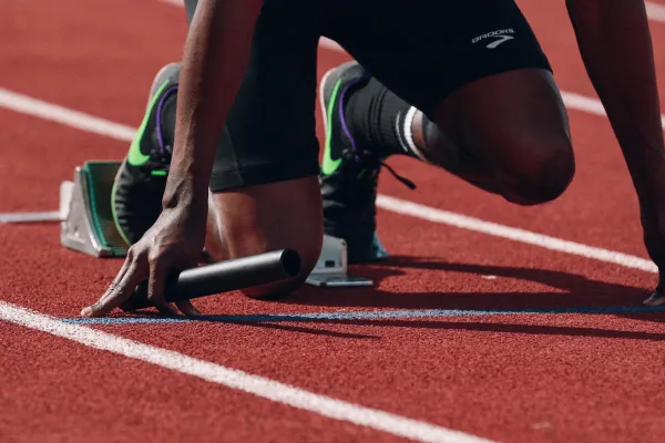 Athlete preparing to run relay on a track